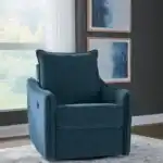 Full styled view of the McBurg Swivel Power Recliner in navy blue, closed, staged in a modern room setting with windows and complementary blue wall art.