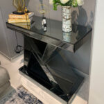 Dark gray N-shaped mirrored console table showcasing stylish decor