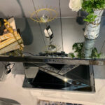 Dark gray N-shaped mirrored console table showcasing stylish decor