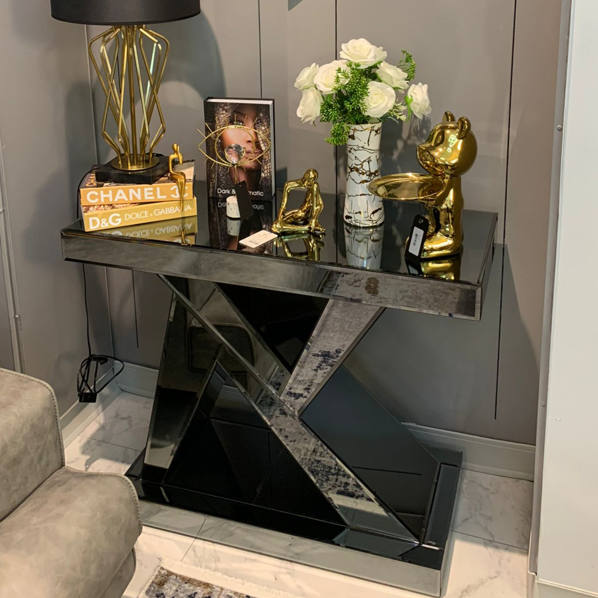 Dark gray N-shaped mirrored console table showcasing stylish decor