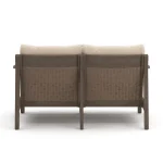 Straight back view of Patara Outdoor loveseat with Beige Cushions displaying dual wicker panels and dark brown wood finish
