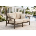 Side profile of Patara wood Outdoor loveseat with Beige Cushions depth, dark brown armrest, and patterned accent pillow