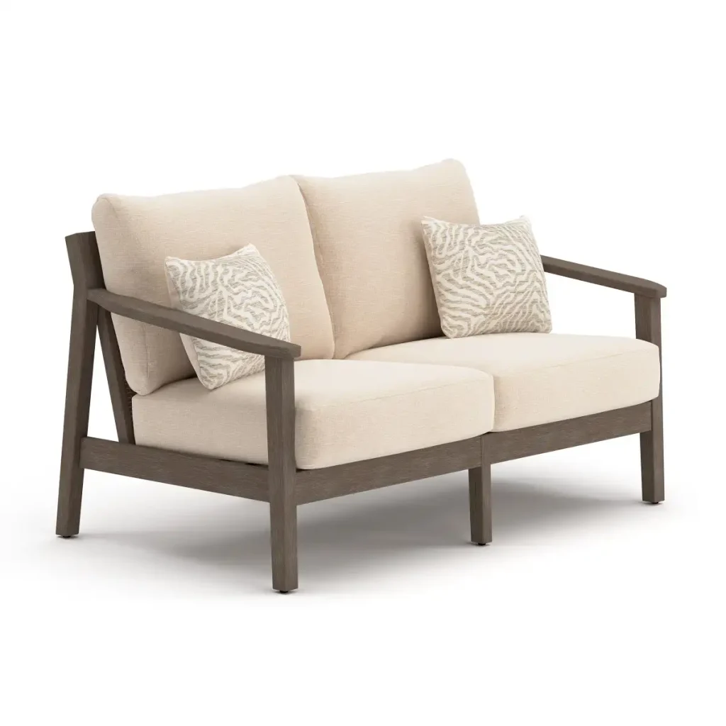 Side profile of Patara wood Outdoor loveseat with Beige Cushions depth, dark brown armrest, and patterned accent pillow