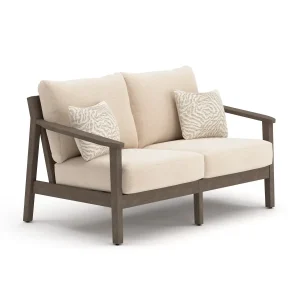 Side profile of Patara wood Outdoor loveseat with Beige Cushions depth, dark brown armrest, and patterned accent pillow
