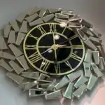 A 33.5" gold wall clock with a black face and golden mirrored panels in an abstract geometric design.