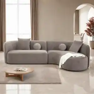 A contemporary Revello sectional sofa in light brown chenille with a curved design and accent pillows.
