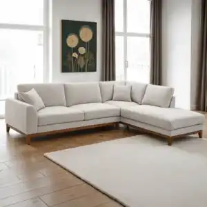 A stylish Watton Mid-Century Modern sectional sofa in light gray chenille fabric, featuring a right chaise and warm walnut tone wood trim, set in a bright living room.