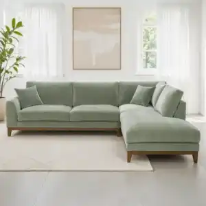 A contemporary Watton Mid-Century Modern sectional sofa in olive green chenille fabric, featuring a right chaise and warm walnut tone wood trim, set in a bright living room.
