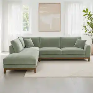 A contemporary Watton Mid-Century Modern sectional sofa in olive green chenille fabric, featuring a left chaise and warm walnut tone wood trim, set in a bright living room.