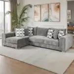 A wide Artesia transitional sectional sofa in charcoal gray fabric, with a chaise lounge, track arms, and decorative throw pillows in a modern living room setting.