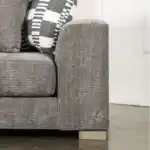 A wide Artesia transitional sectional sofa in charcoal gray fabric, with a chaise lounge, track arms, and decorative throw pillows in a modern living room setting.