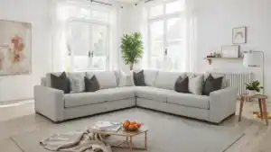 Romsey Light Gray Sectional Sofa with track arms and accent pillows in a bright transitional living room.