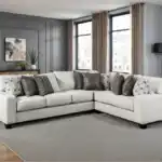 White Millburn Sectional Sofa with L-shaped design and accent pillows.