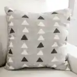 Millburn Sectional Sofa gray triangle patterned accent pillow.