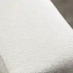 Millburn Sectional Sofa white fabric upholstery texture close-up.