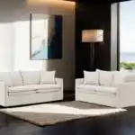 Pair of taupe linen loveseats with feather blend cushions by fireplace in Tampa showroom