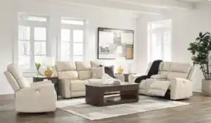 Dahlmoore 3-piece living room set featuring a power sofa, loveseat, and recliner in almond-tone top grain leather, displayed in a modern, light-filled room at the furniture store Tampa.