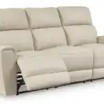 Dahlmoore power sofa with footrests extended, showing the individual power recline function on the outer two seats. Almond top grain leather finish and durable metal mechanism.