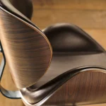 Brown leather curved seat with walnut finish on Alex bar stool