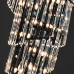 Illuminated K9 crystal prisms on a black crystal chandelier