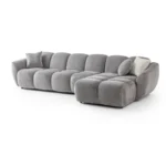A modern gray boucle sectional sofa with a curved design in a stylish living room.