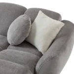 A modern gray boucle sectional sofa with a curved design in a stylish living room.