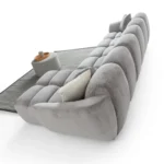 A modern gray boucle sectional sofa with a curved design in a stylish living room.