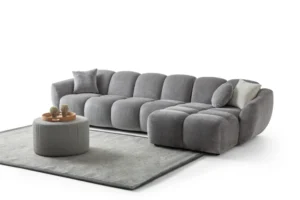 A modern gray boucle sectional sofa with a curved design in a stylish living room.