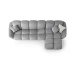 A modern gray boucle sectional sofa with a curved design in a stylish living room.