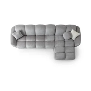 A modern gray boucle sectional sofa with a curved design in a stylish living room.