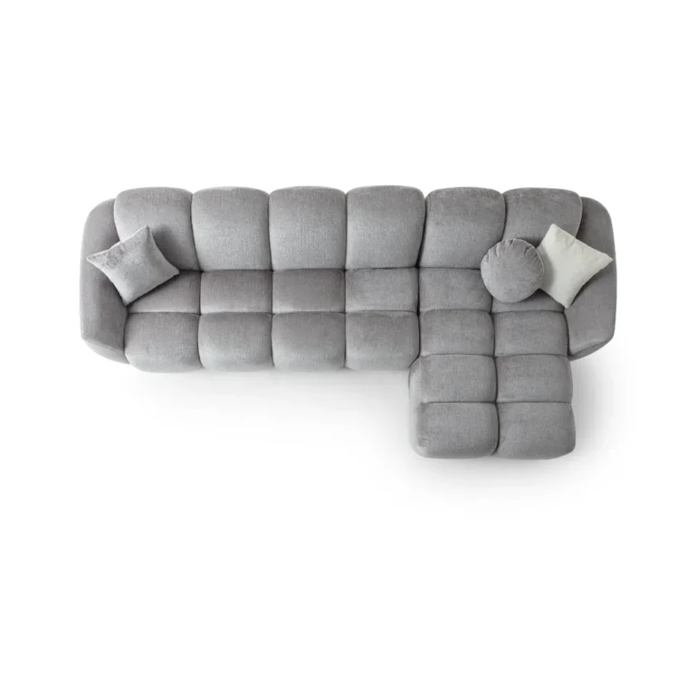 A modern gray boucle sectional sofa with a curved design in a stylish living room.