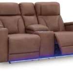Clean-Slate Caramel Power Loveseat with console, partially reclined, showing the blue LED ambient base lighting and side arm storage.
