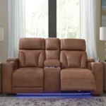 Clean-Slate Caramel Power Loveseat fully reclined in a living room setting, featuring the center console and blue LED lighting activated.