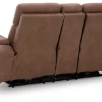 Close-up of the Clean-Slate Loveseat's center console storage, showing the illuminated cup holder and the open storage compartment with a remote.