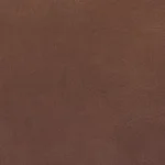 Close-up texture shot of the Caramel faux leather upholstery used on the Clean-Slate Power Reclining Sofa, showing the rich color and quality stitching.
