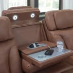 Close-up of the Drop-Down Center Table on the Caramel Power Reclining Sofa with LED reading lights, charging ports, and cup holder.