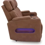 Side profile of the Clean-Slate Caramel Reclining Sofa showing the blue LED ambient lighting cutouts and the power control buttons.