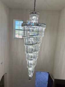 Luxury Staircase Chandelier – 8.5 ft high ceiling chandelier with K9 crystals in a modern home.