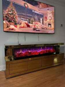 Gold mirrored fireplace TV stand with four storage compartments and electric fireplace