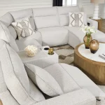 High-angle view of a 6-piece light gray reclining sectional with console and power chaise in a modern living room.