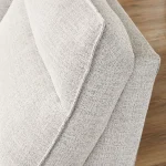 Macro view of the premium gray Nuvella performance fabric and tailored stitching on a sectional sofa.