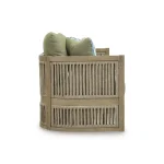 Side profile of Gumbet curved green outdoor sofa showing rope-wrapped arm detail, sage green cushions, and layered eucalyptus wood construction