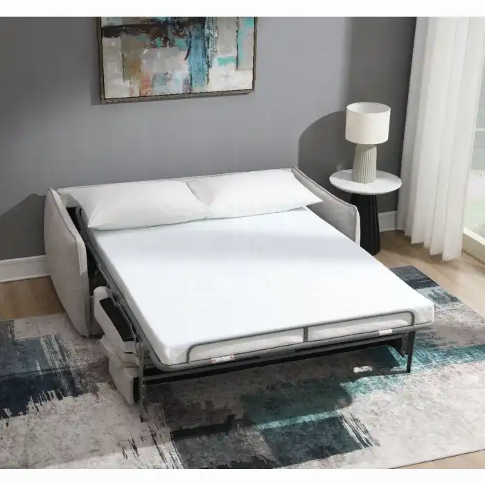 Jinn Sleeper Sofa fully open in bed position, featuring the full-size memory foam mattress set up in a cozy, modern guest room environment.