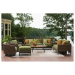 Brown and green outdoor sofa with coordinating patio chairs and table