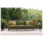 Modern green outdoor sofa styled on a spacious patio