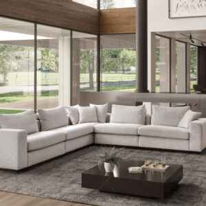 Mondial Sectional Sofa in a modern living room with customizable fabric and leather options.