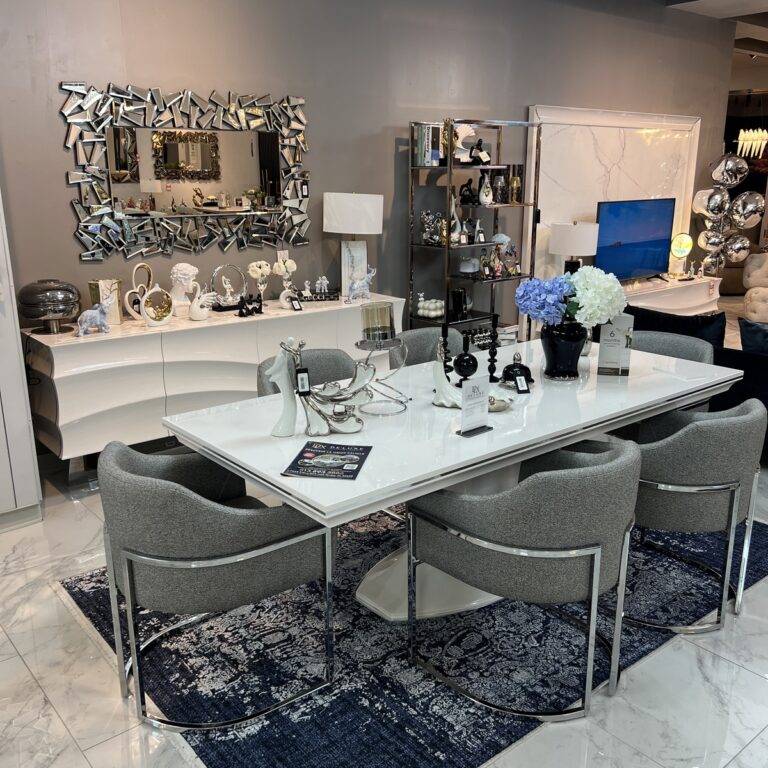 Infinity Dining Room Set with white lacquer table, silver detailing, grey dining chairs, and a matching sideboard and mirror.
