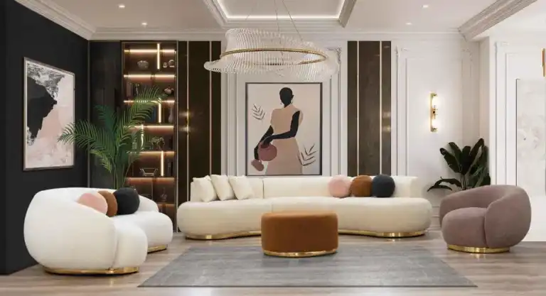 Elegant curved sectional sofa with gold base in a modern living room setting, featuring neutral tones and plush cushions.