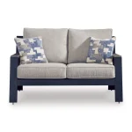 Front view of Sile navy blue outdoor loveseat with beige cushions and geometric throw pillows on white background