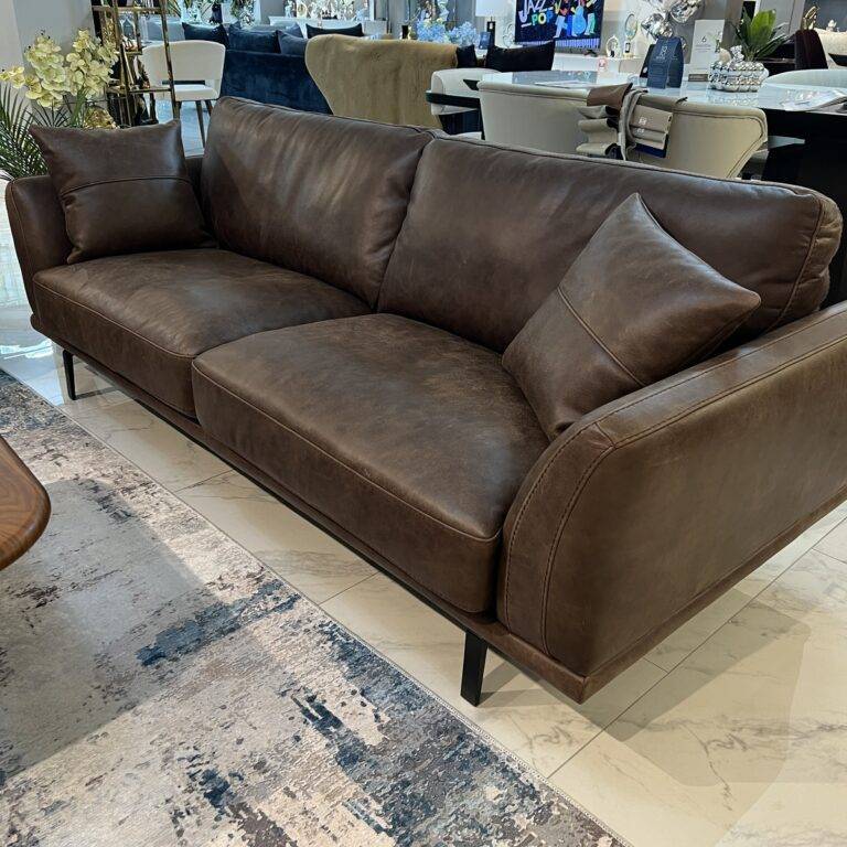 Original Italian leather sofa in dark brown with plush cushions.